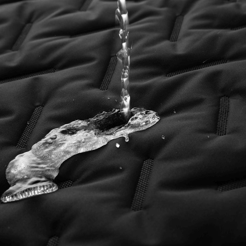 Water-resistant fabric of the Warm Casual Male Lambswool Vest, demonstrating waterproof feature with water beading off surface.